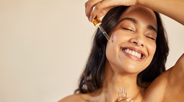 women applying vitamin c serum