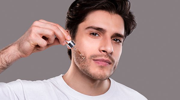 men applying serum